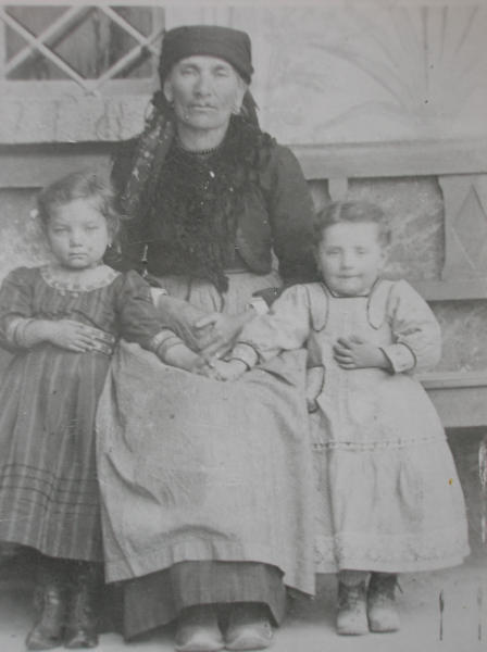 Donna con bambine in abiti tradizionali